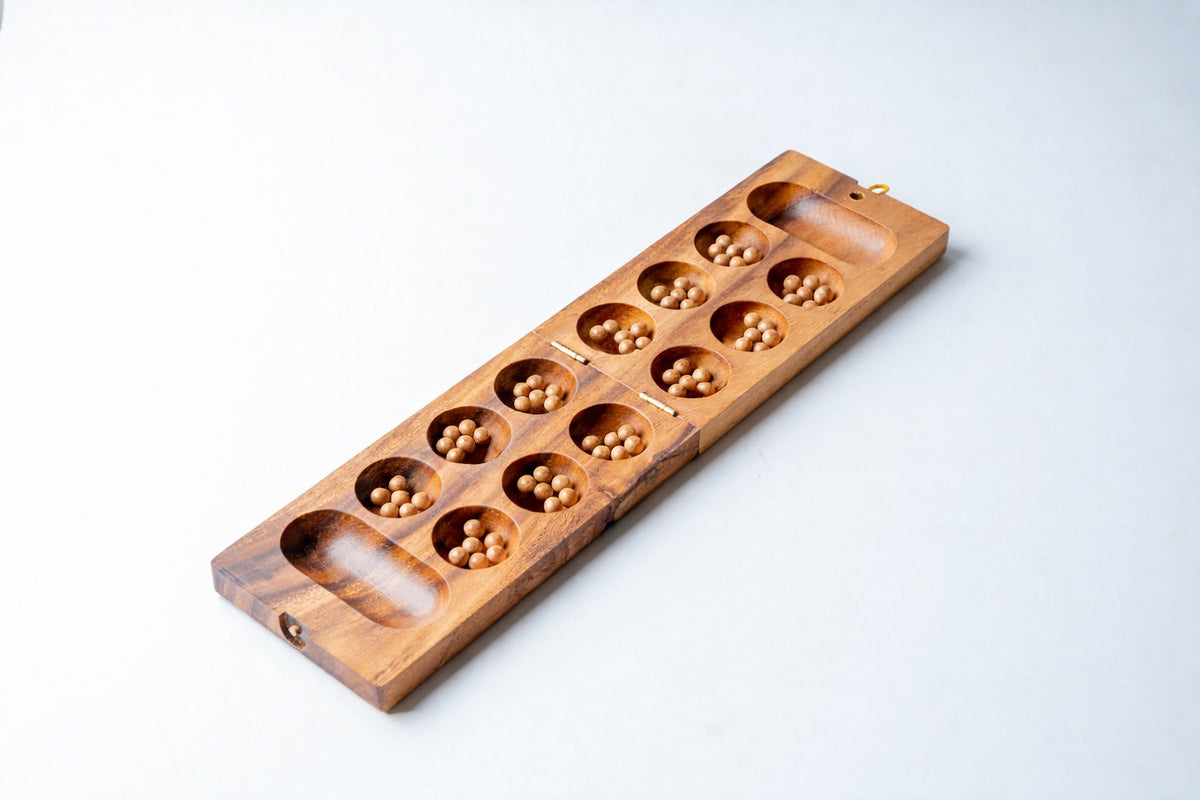 Wooden mancala board with twelve circular cups containing small beads and two end storage pockets.