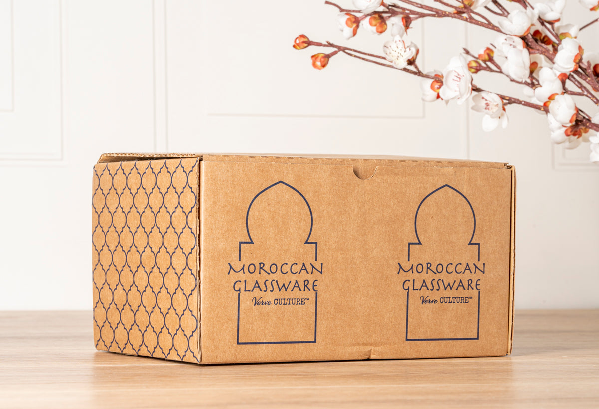 Brown cardboard box with Moroccan arch design and "Moroccan Glassware" text printed on side.