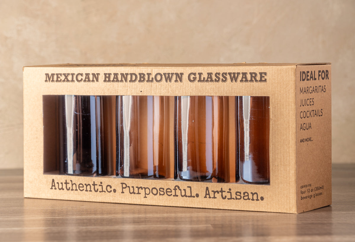 Set of four tamarind-colored handblown glasses in cardboard packaging with window display.