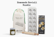 Ravioli bundle containing cream drawstring bag with mold and pin, metal ravioli press, pasta flour box, pesto jar, and wooden