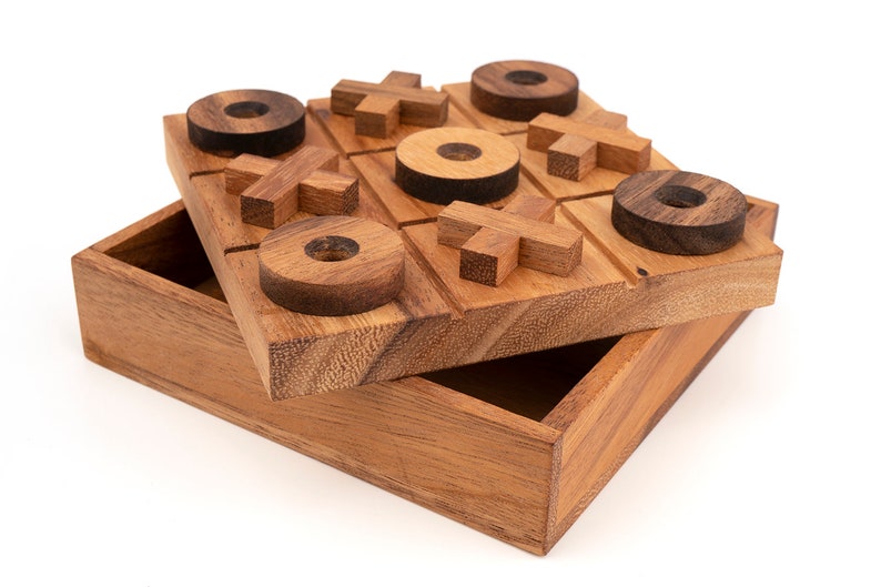 Wooden tic-tac-toe game set with carved board, circular X pieces, square O pieces, and storage box in natural and dark wood t