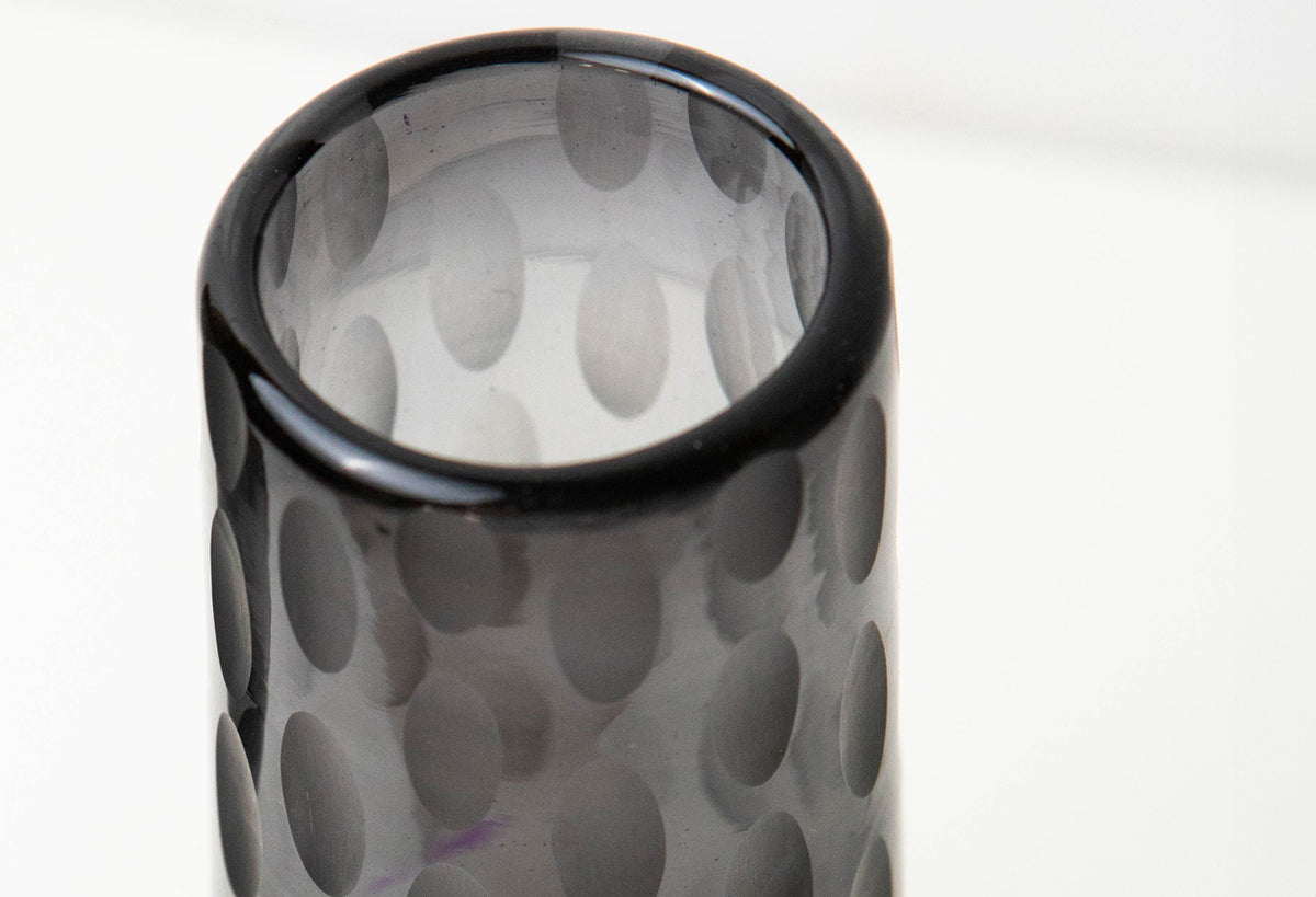 Clear glass champagne flute with etched oval pattern and black rim, shown from above.