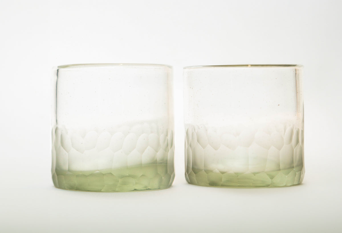 Two clear rocks glasses with etched mountain pattern and pale green tinted lower sections.