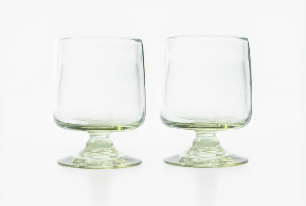 Two clear glass tumblers on a white background