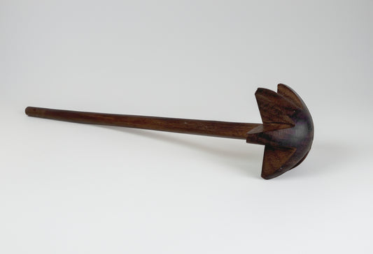 Wooden whisk with dark brown handle and paddle-shaped head with vertical slats for stirring.