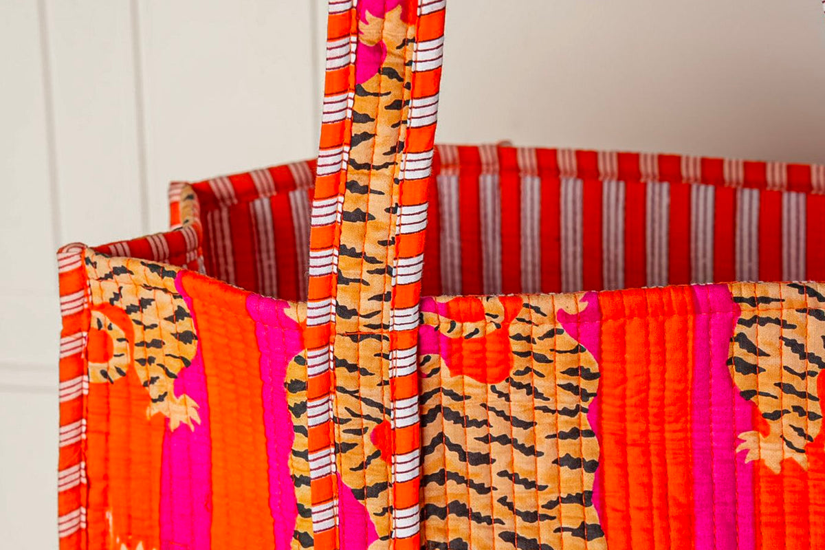 Quilted tote bags with orange, pink, and striped patterns featuring cat prints and handles.