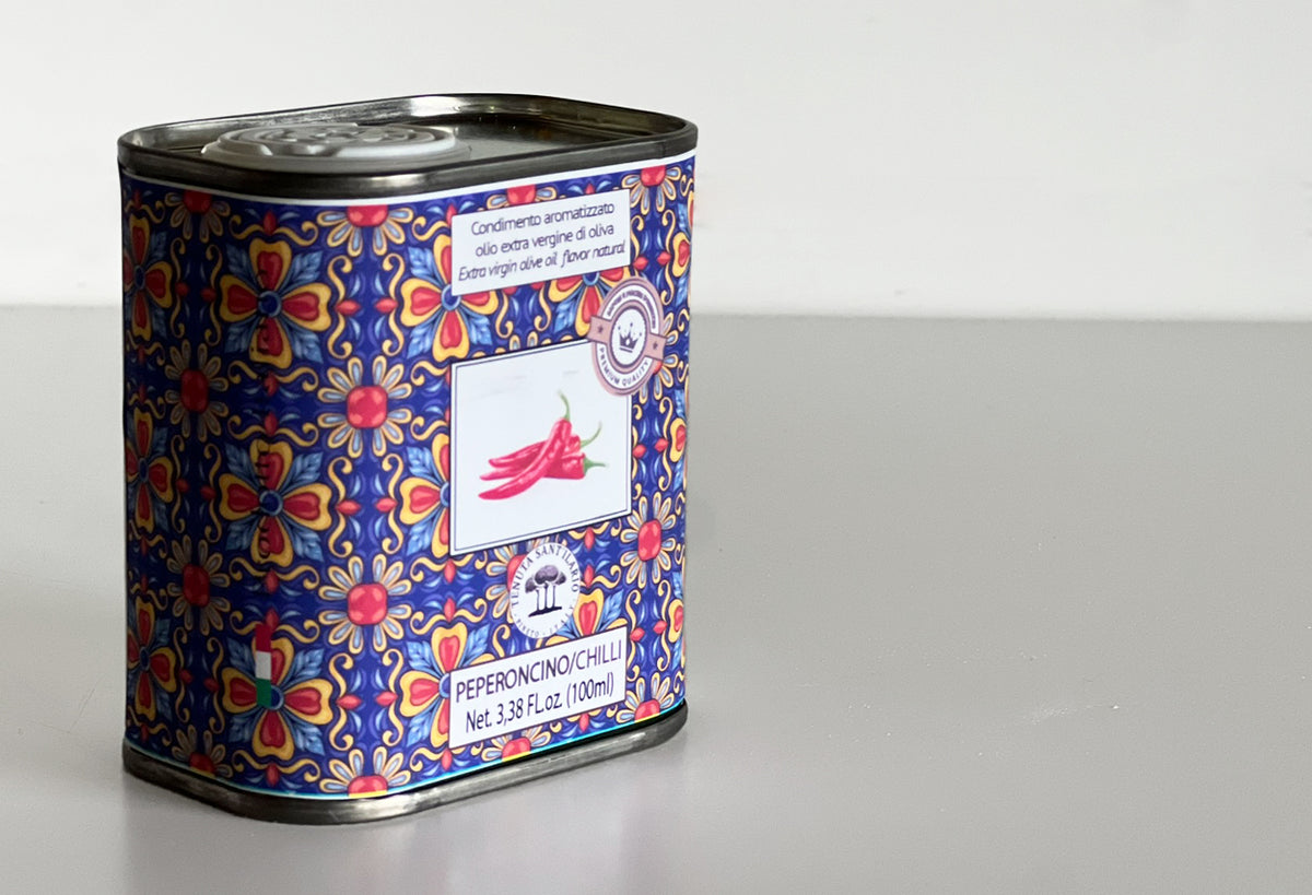 Metal tin with blue and red floral pattern, labeled peperoncino chilli olive oil, 3.38 fl oz.
