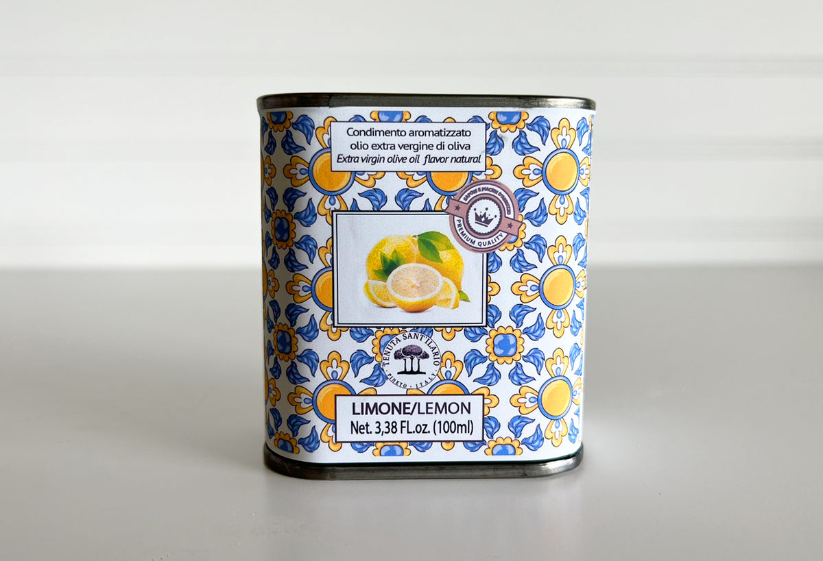 Lemon-infused extra virgin olive oil tin with blue and yellow decorative pattern, 100ml.