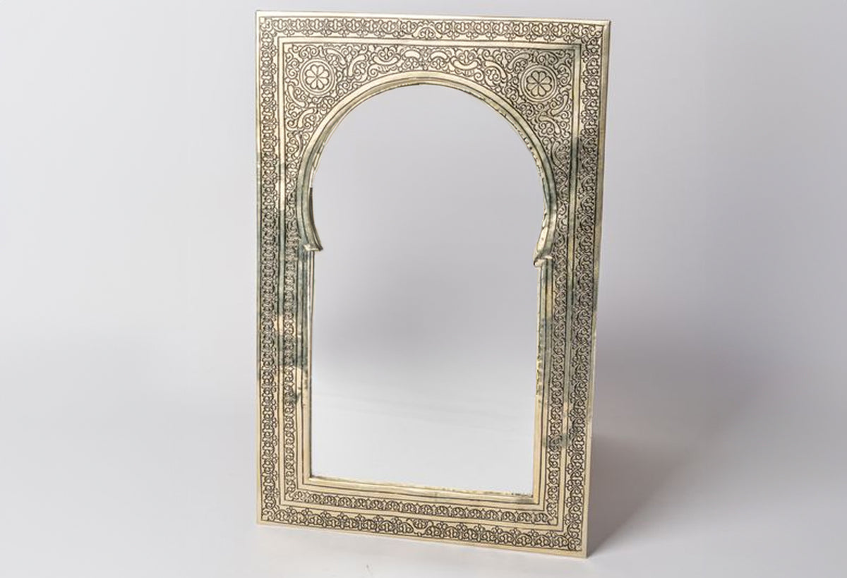 Rectangular mirror with ornate arched frame featuring intricate geometric and floral patterns in cream and gold tones.