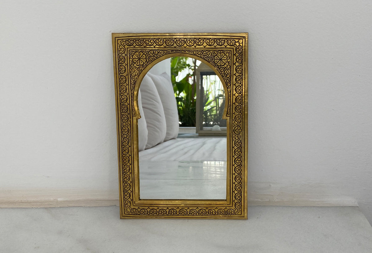 Rectangular mirror with ornate gold-toned frame featuring intricate geometric and floral patterns in Moroccan style.