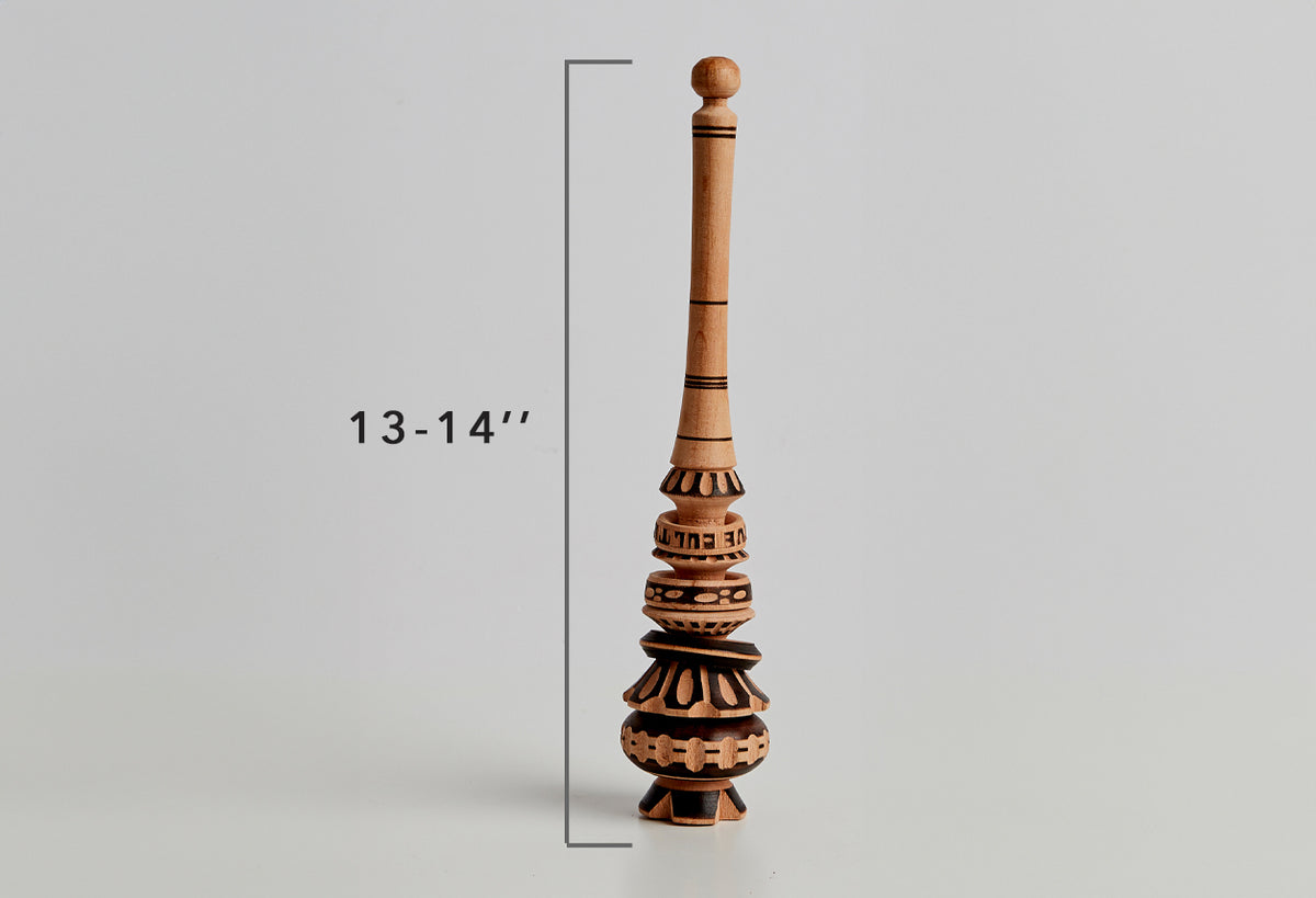 Wooden molinillo whisk with carved decorative sections and black inlay bands, 13-14 inches tall.