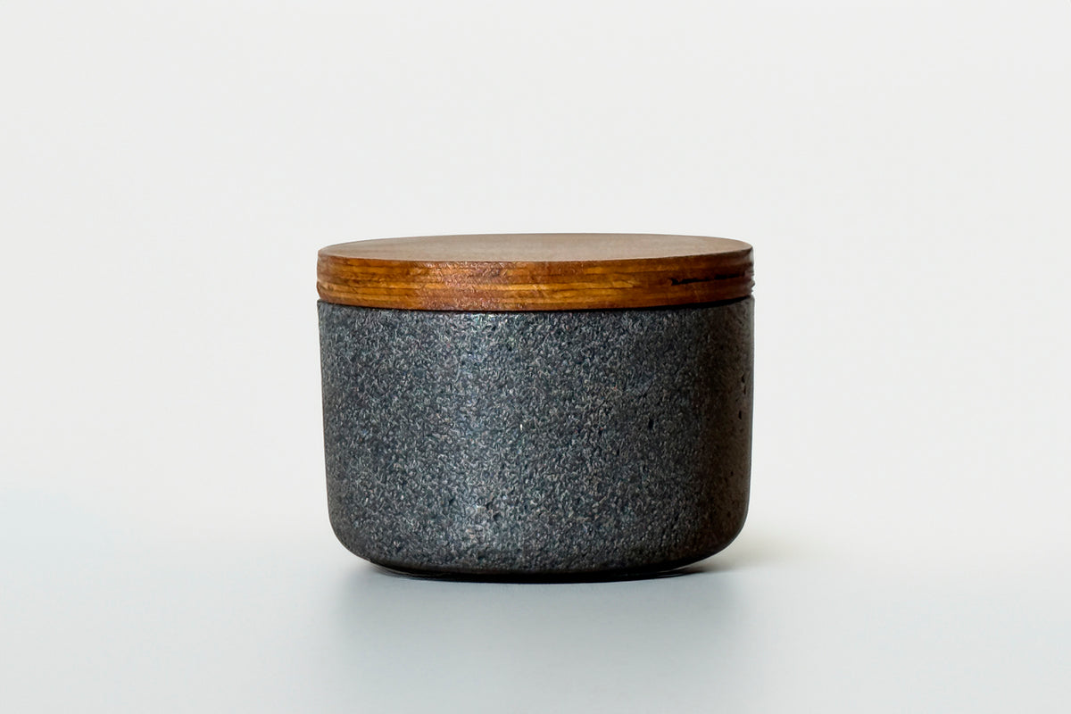 Dark gray concrete container with natural wood lid.