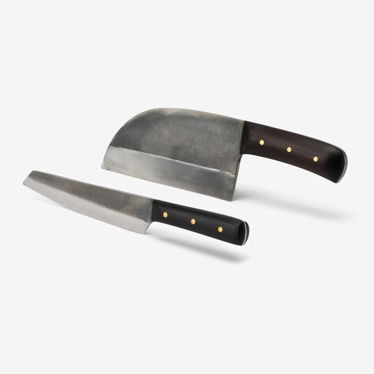 Two chef's knives with dark wooden handles and brass rivets, featuring wide curved and straight blades.