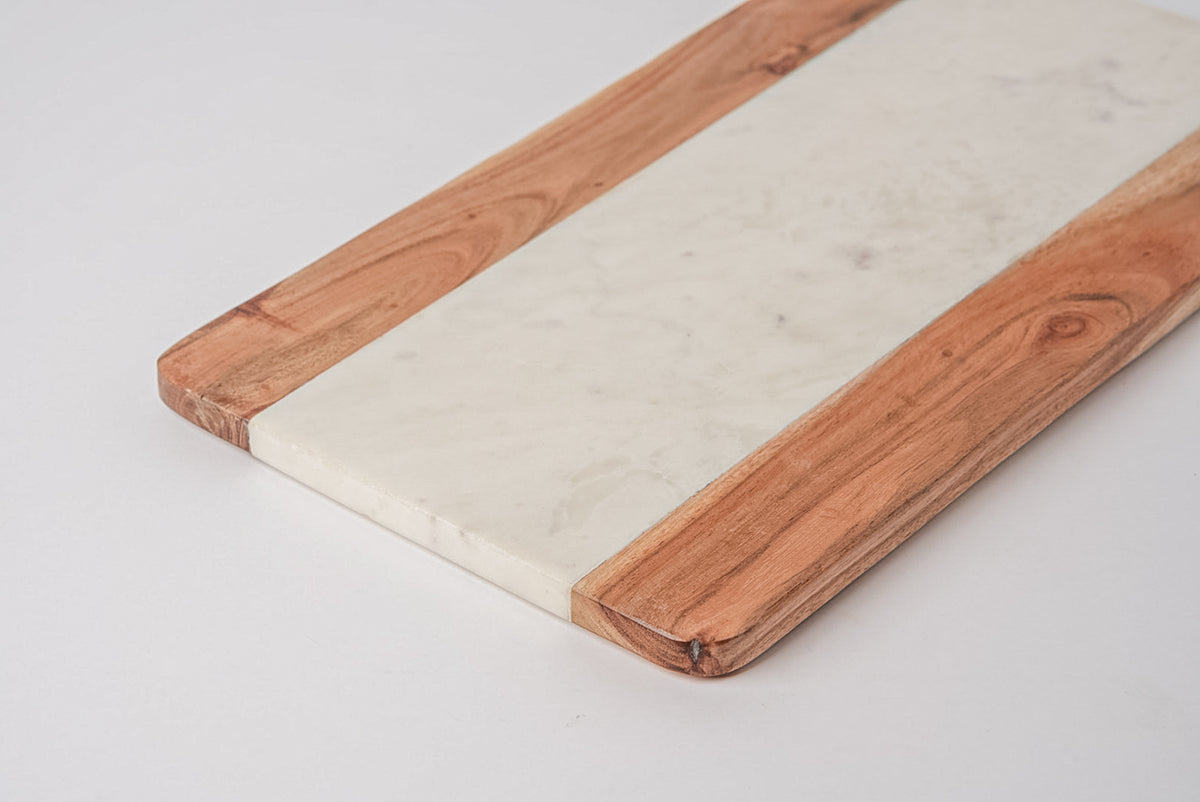 Rectangular serving board with white marble center strip flanked by acacia wood sides.