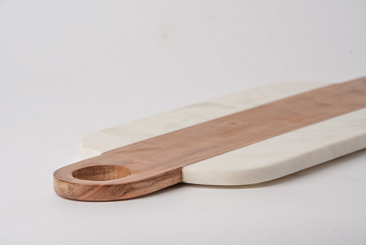 Rectangular serving boards with rounded handles, one in white marble and one in light wood with circular hole handle.