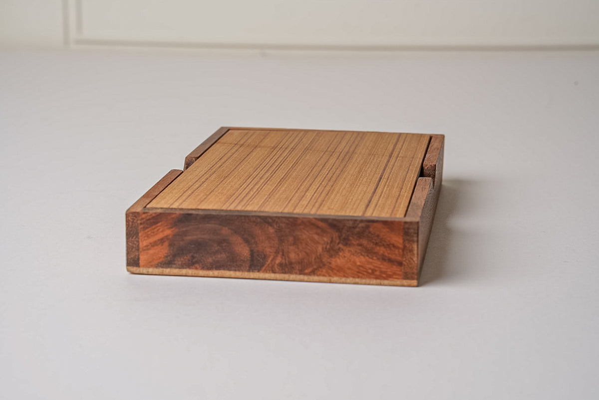 Wooden domino set case with light wood slat top and darker grain-patterned wood sides.