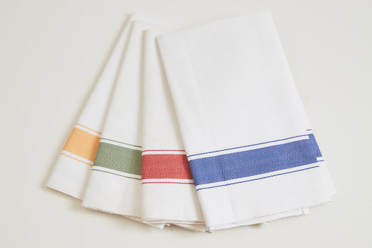 Four cream kitchen towels with herringbone weave and colored stripe trim in orange, green, red, and blue.