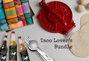 Red tortilla press, colorful striped kitchen towels, habanero hot sauces, measuring spoon, and flour tortillas displayed toge