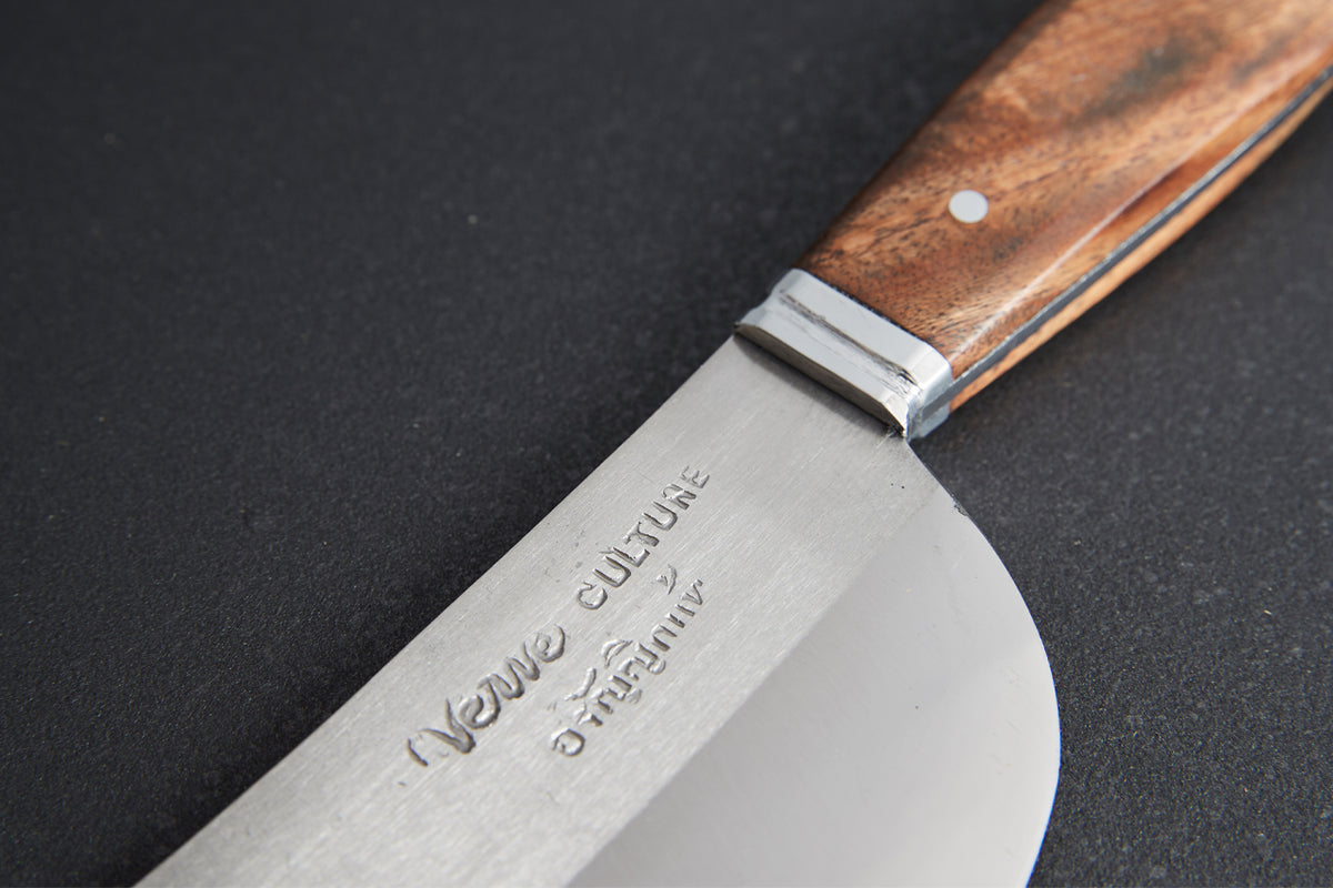 Chef's knife with wide curved blade, brown wooden handle, and metal band near the grip against dark background.
