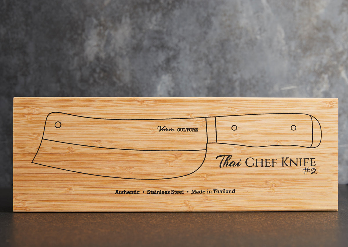 Bamboo box with engraved outline of a Thai chef's knife, labeled "Verso Culture Thai Chef Knife #2," indicating stainless ste