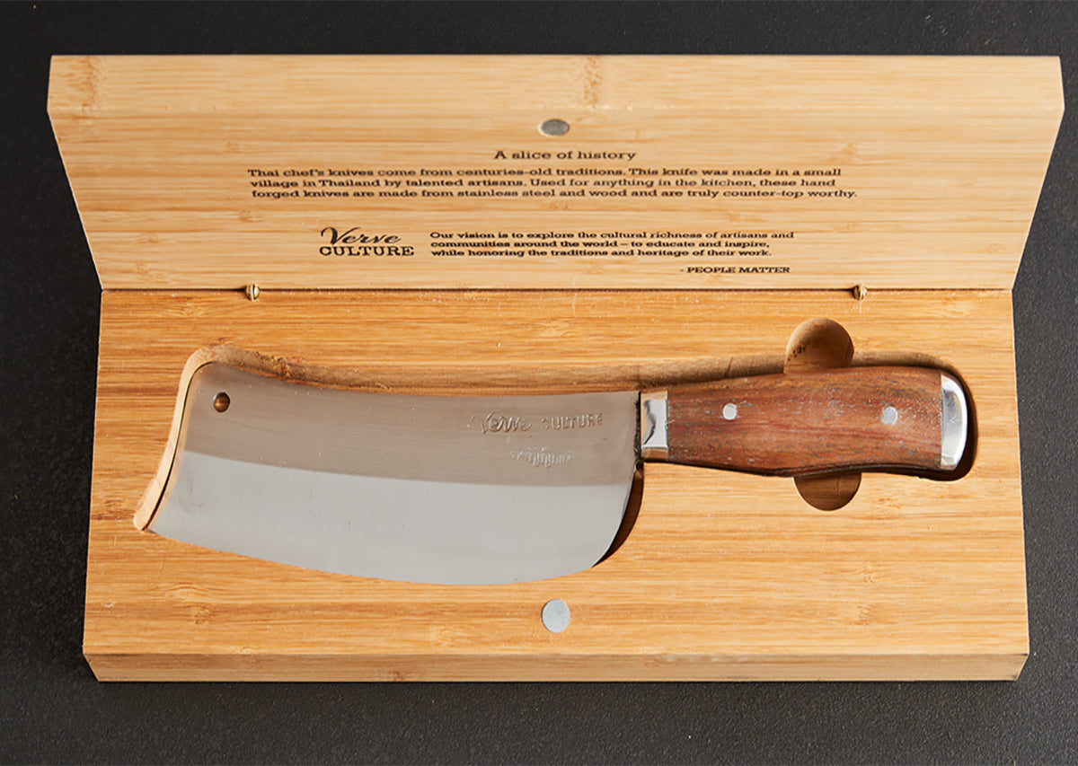 Thai chef's knife with wooden handle displayed in open bamboo box with engraved text.