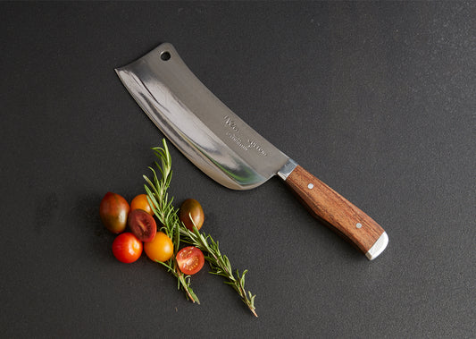 Thai chef's knife with wide rectangular blade, wooden handle, and hole at top, displayed with fresh tomatoes and rosemary spr