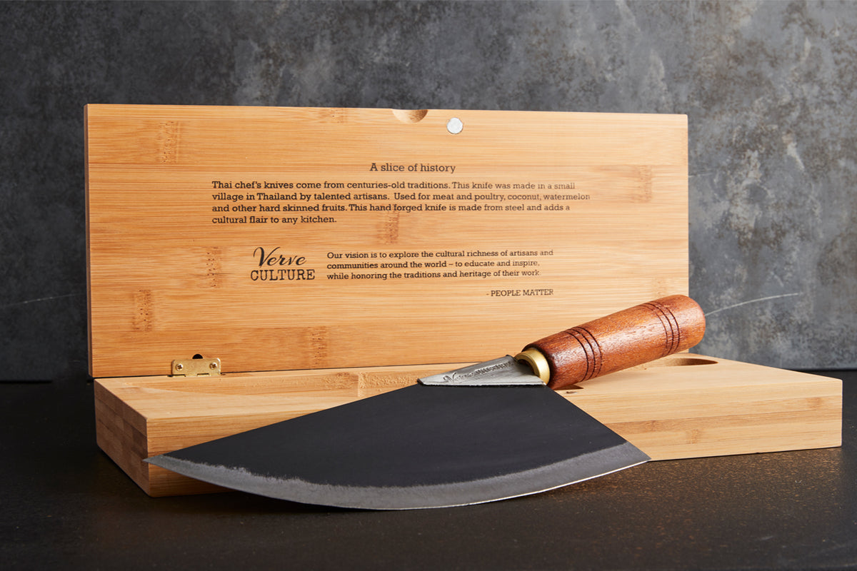 Curved metal blade with wood handle resting on bamboo presentation box with engraved text.