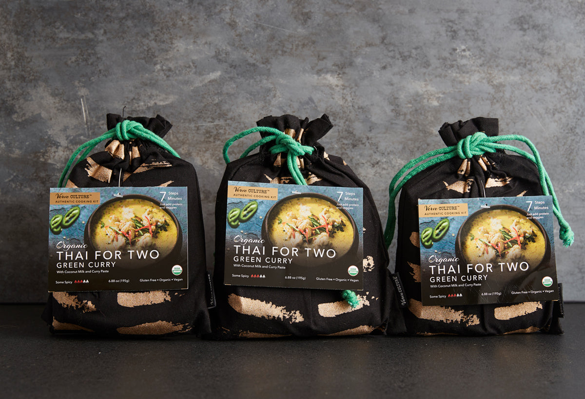 Three black pouches with green drawstring ties containing Thai green curry kits, each labeled "Thai for Two" with product ima
