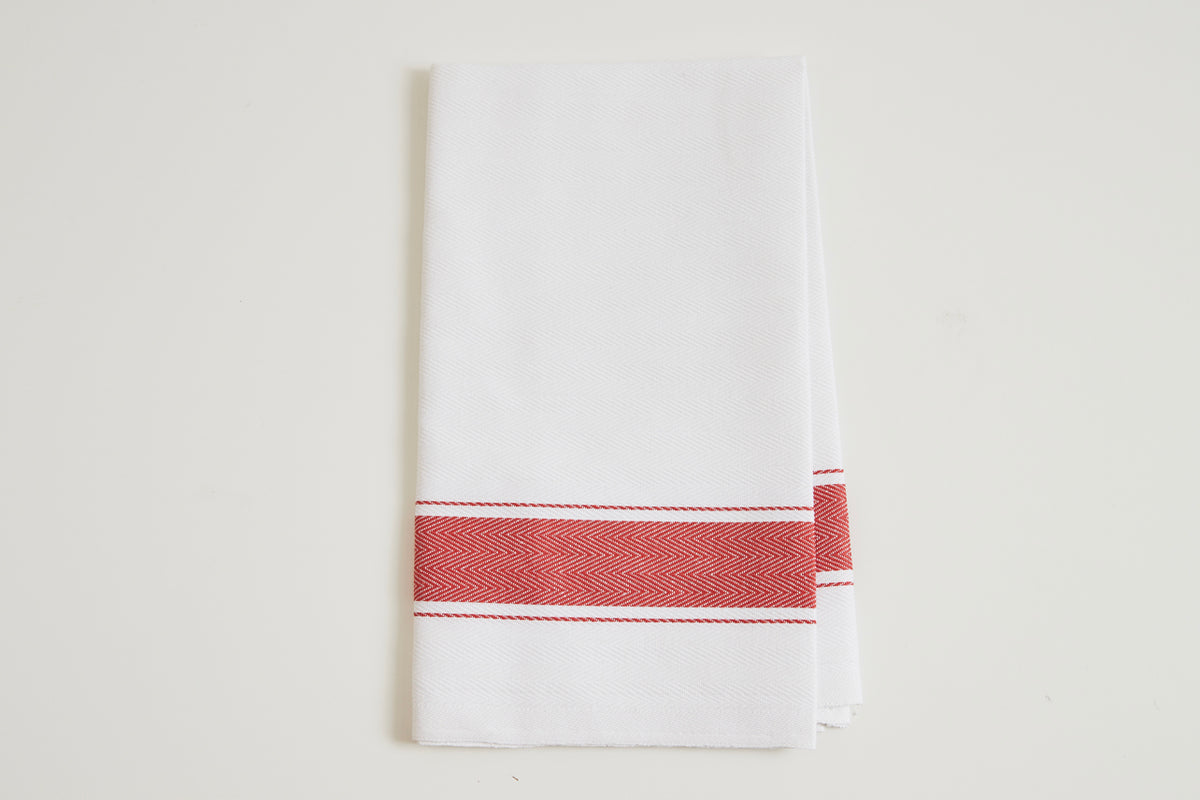 White kitchen towel with red herringbone stripe band across the middle.