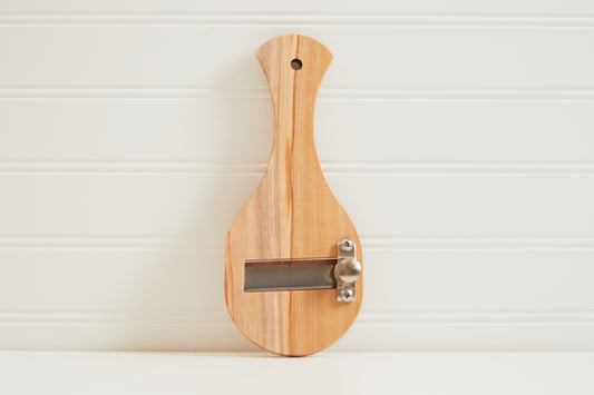 Light wood truffle slicer with metal blade and hanging hole.