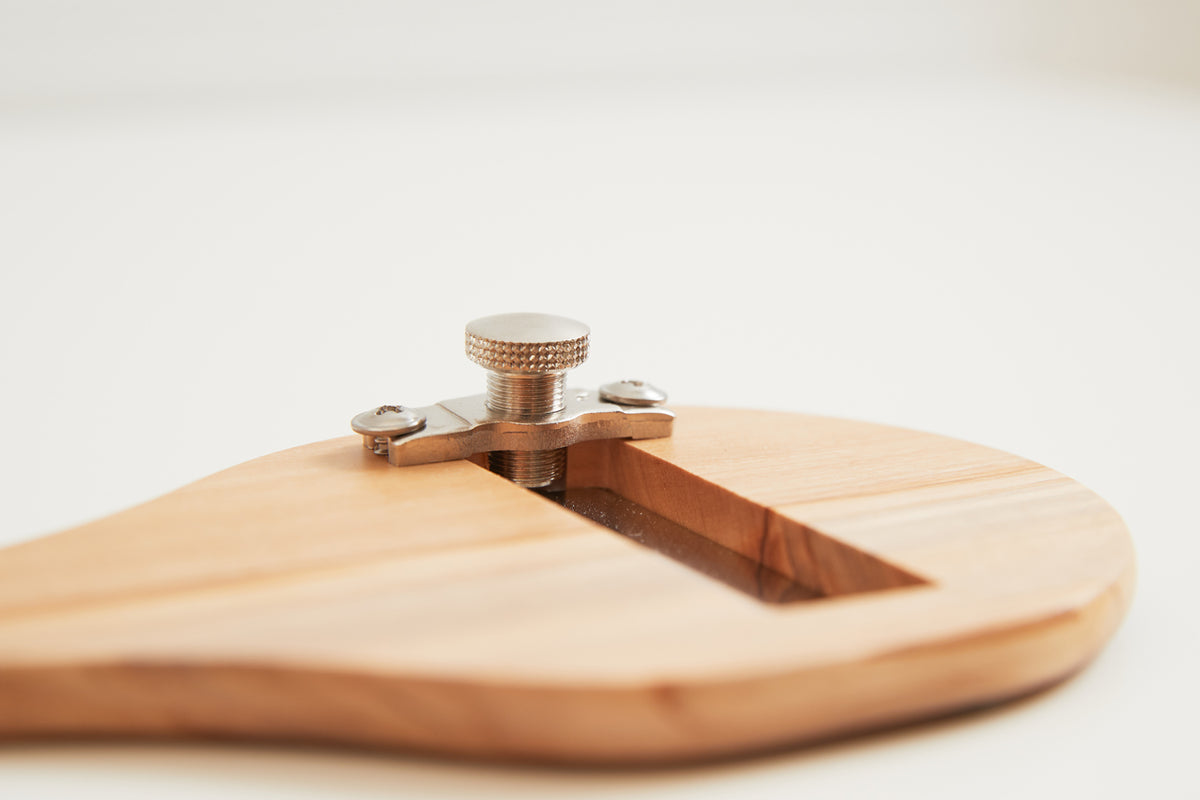 Olivewood slicer with adjustable metal blade and brass knurled screw on rounded wooden base.