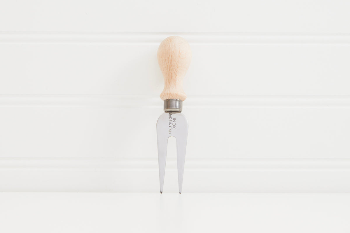 Three-pronged cheese fork with natural wood handle and metal ferrule on white background.