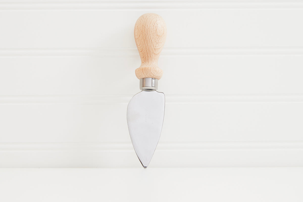Cheese knife with pointed stainless steel blade and natural wood handle against white background.
