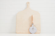 Wooden pizza peel with handle and metal pizza cutter with wooden grip on white background.