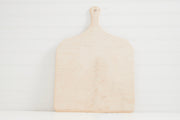 Light wood pizza peel with handle and rounded square paddle on white background.