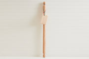 Wooden mattarello pasta rolling pin with handles at both ends and a rectangular dough scraper attached by twine.
