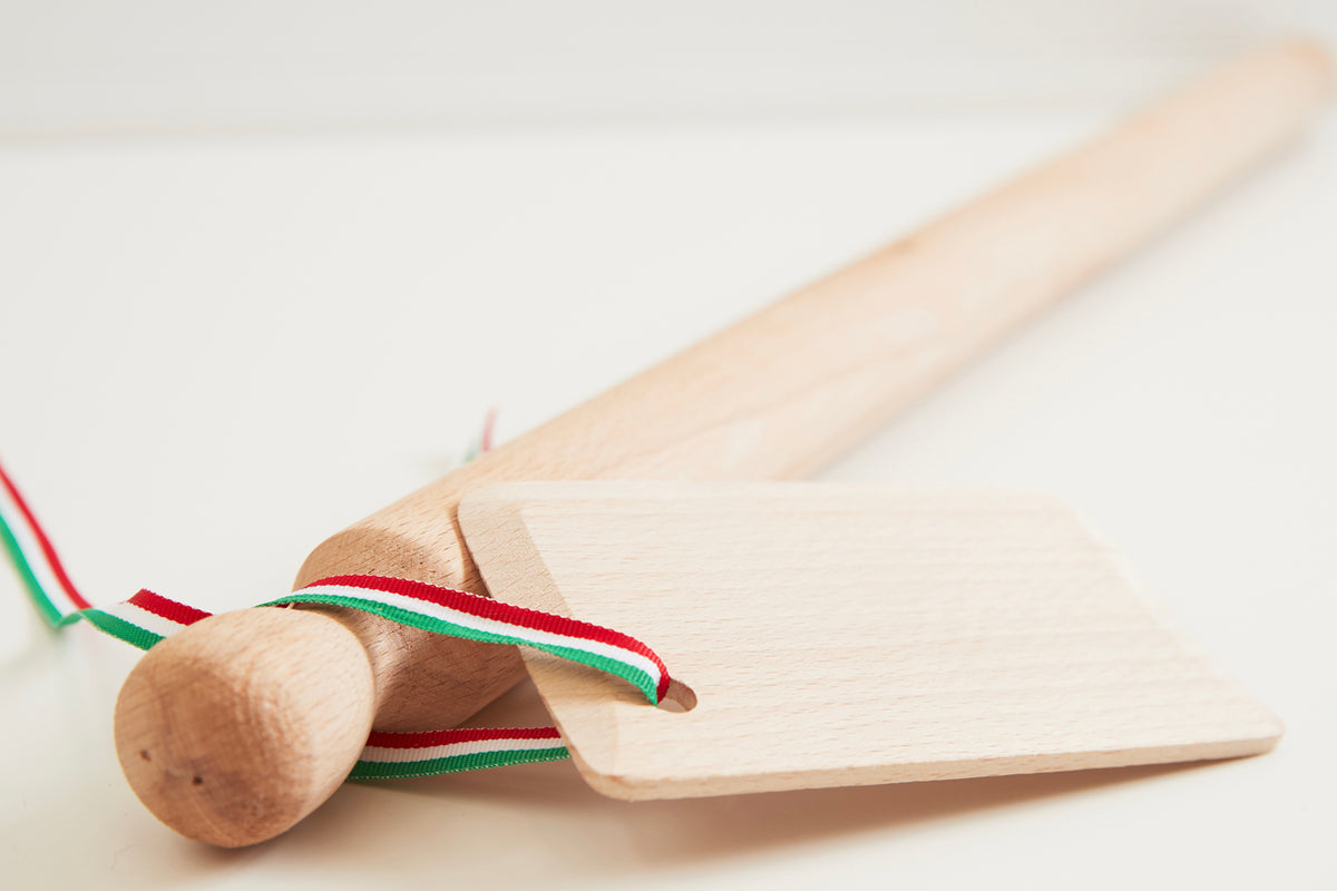 Wooden mattarello rolling pin and rectangular dough scraper with Italian flag ribbon.