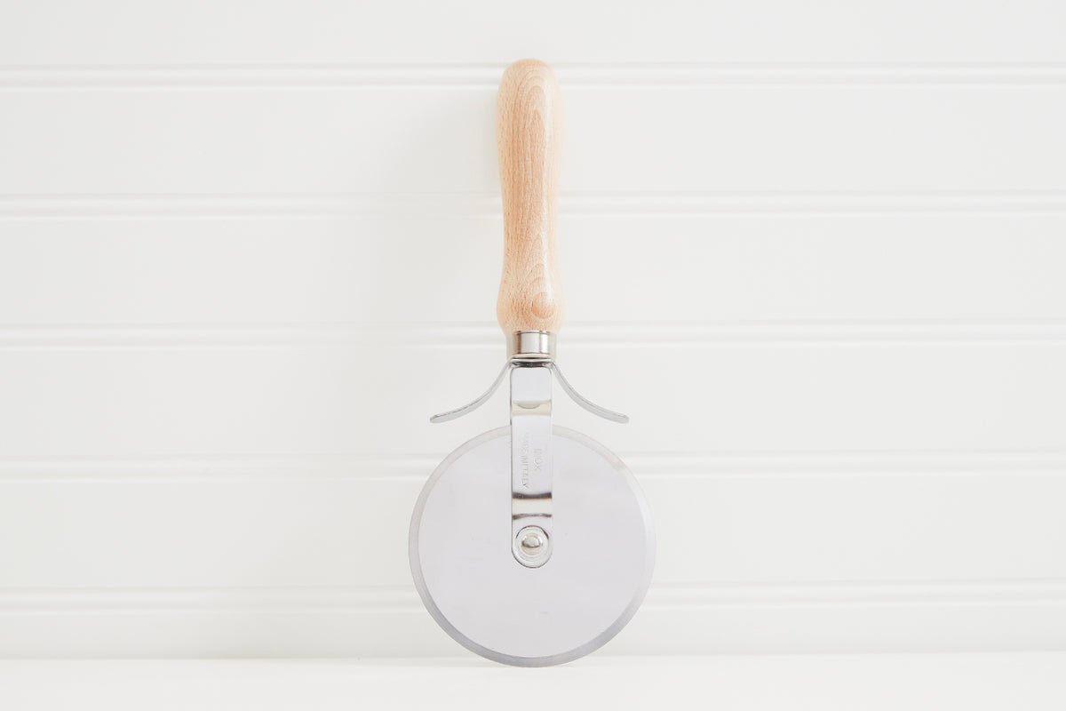 Wooden-handled pizza slicer with circular metal cutting wheel and stainless steel handle supports.