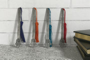 Four metal Hand of Fatima bookmarks with patterned strips and colored tassels in navy, orange, teal, and burgundy.