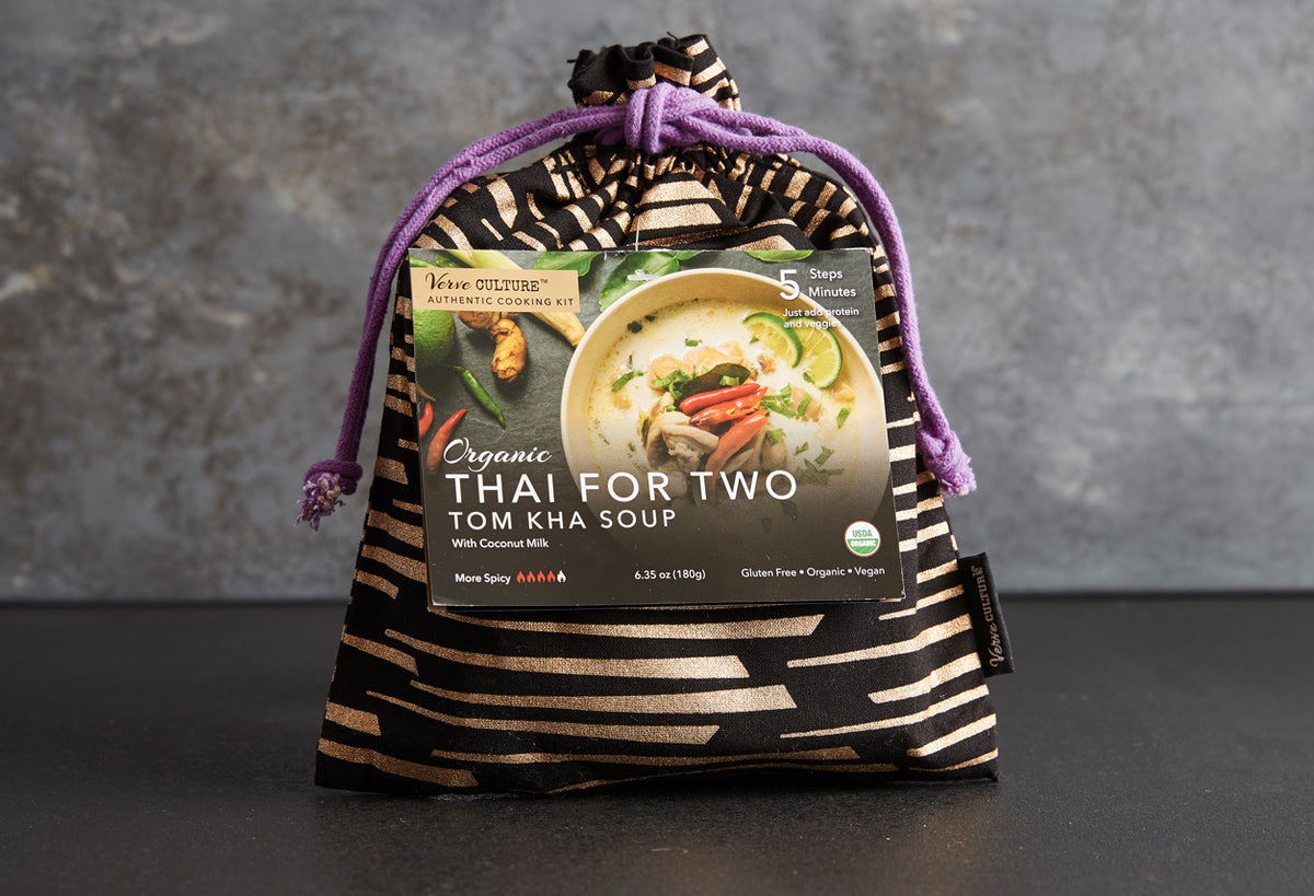 Organic Thai for Two Tom Kha Soup kit in striped fabric pouch with purple drawstring, showing creamy soup bowl with vegetable