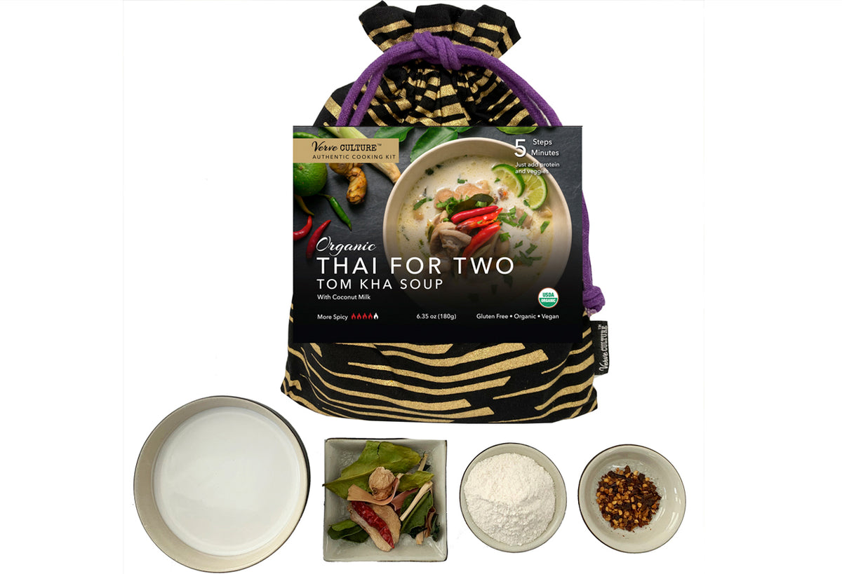 Organic Tom Kha Soup kit with packaging, coconut milk, fresh herbs, and spice components displayed separately.