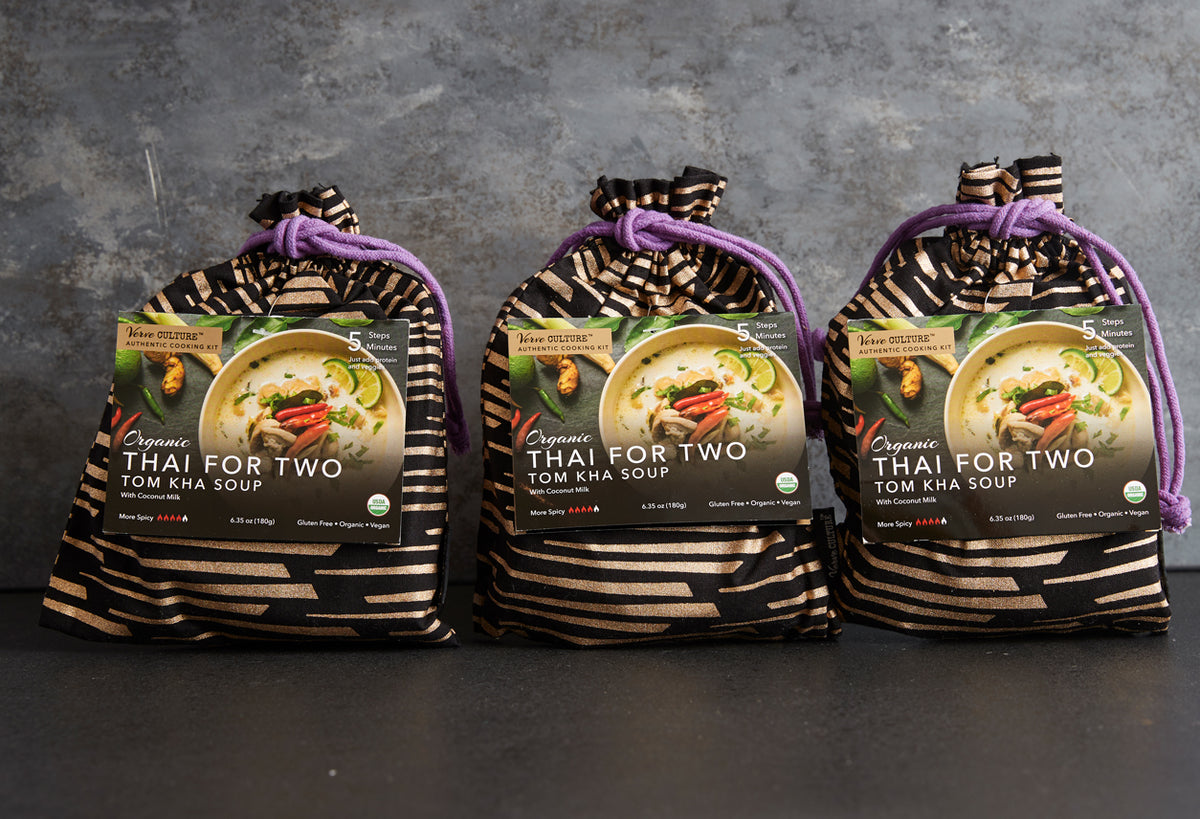 Three packages of organic Thai for two tom kha soup in striped pouches with purple drawstring ties.