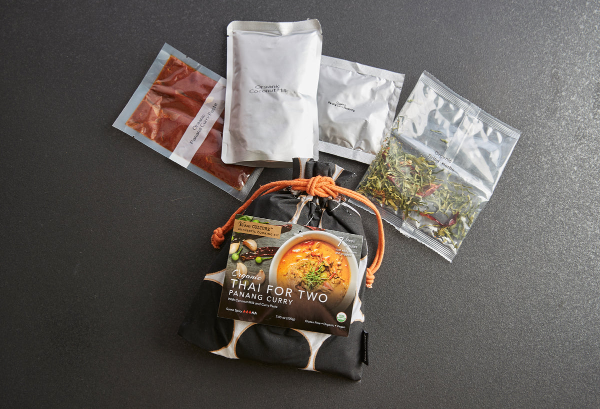 Thai for Two Panang Curry Kit with black and white pouch containing instruction card, curry paste, and dried herb packets.