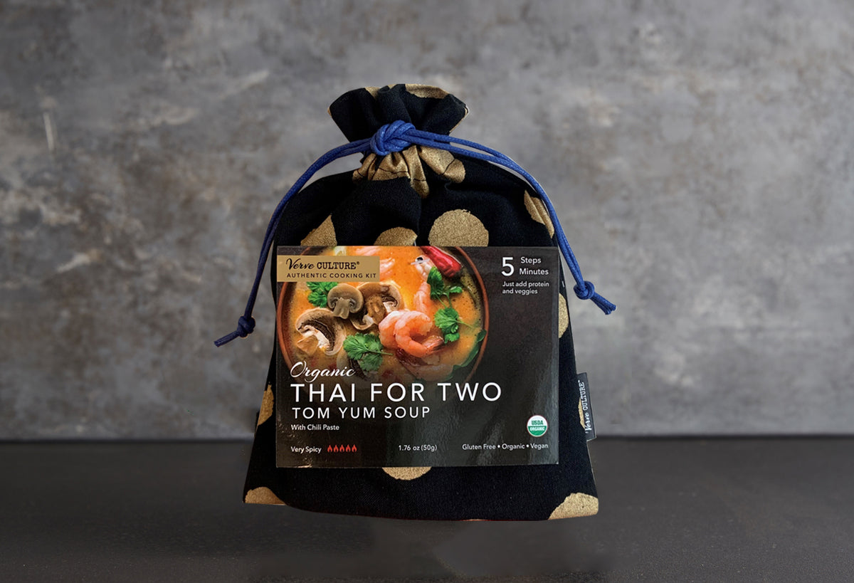 Organic Tom Yum Soup cooking kit in black pouch with blue drawstring, showing product label with shrimp and mushroom soup ima
