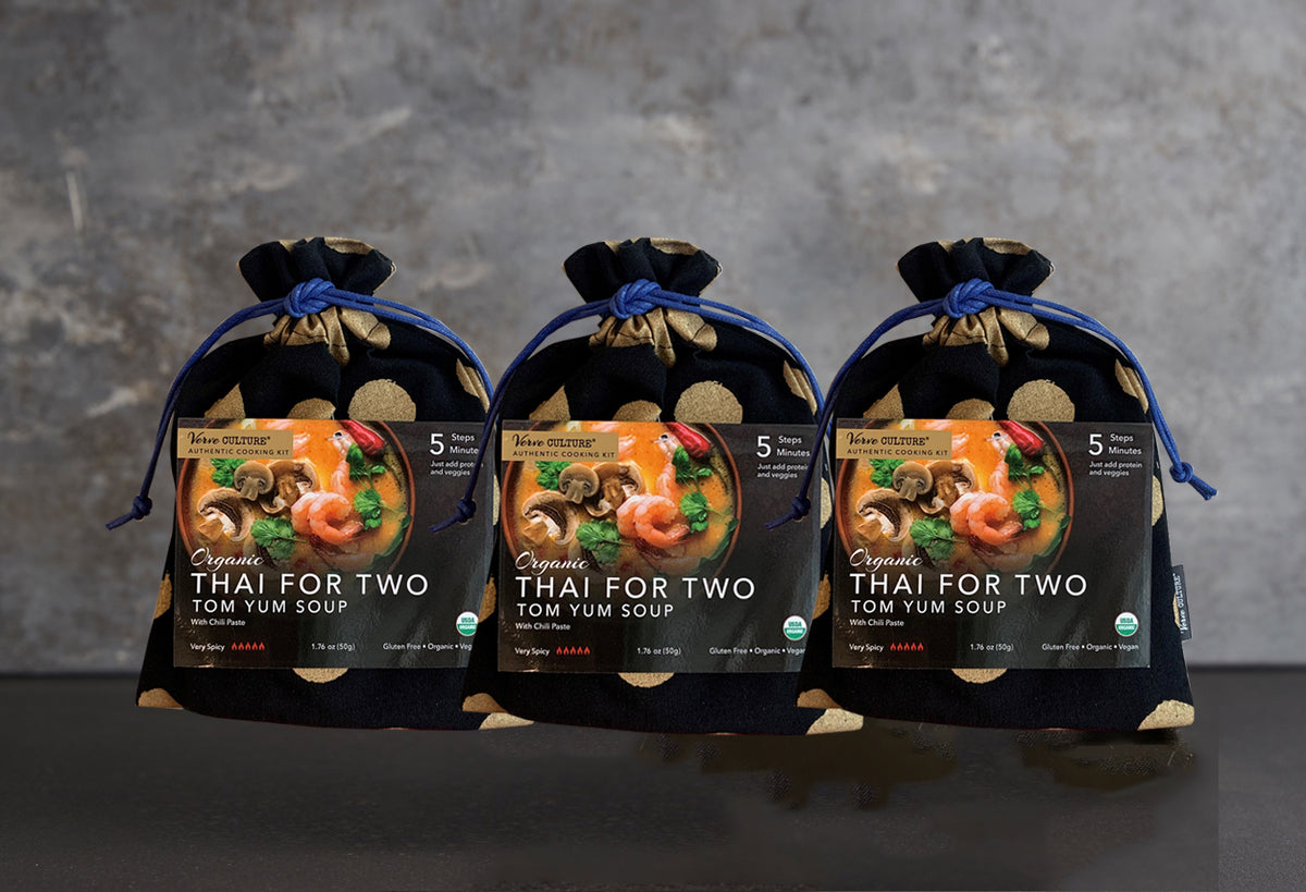 Three black pouches with blue drawstring tops containing organic Thai for Two tom yum soup packets with shrimp and vegetable 
